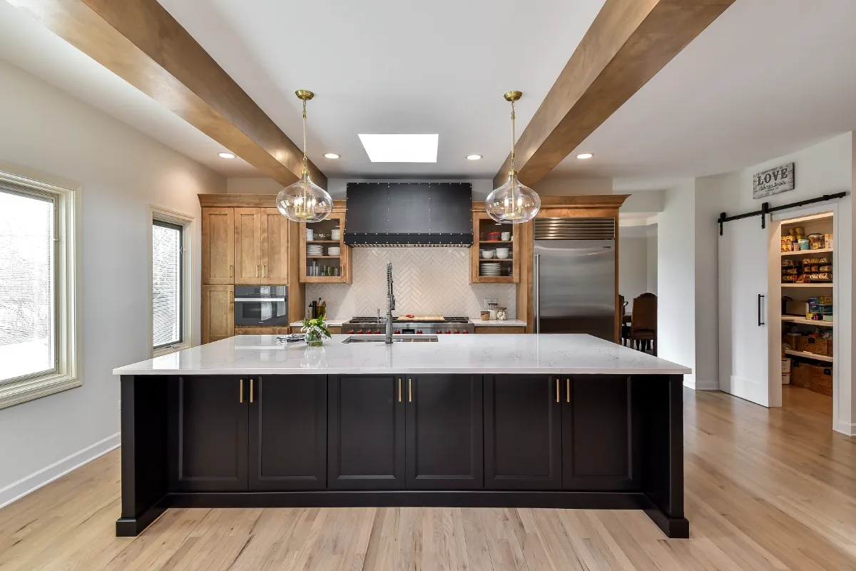A modern-rustic kitchen in Brentwood, TN. CWP Fruitwood on Birch and Bunker Hill Black cabinetry, Cambria Charlestown Matte and Colton Polished quartz, Kohler Tournant faucet, and Ledger Stone Carbon backsplash by Sebring Design Build.