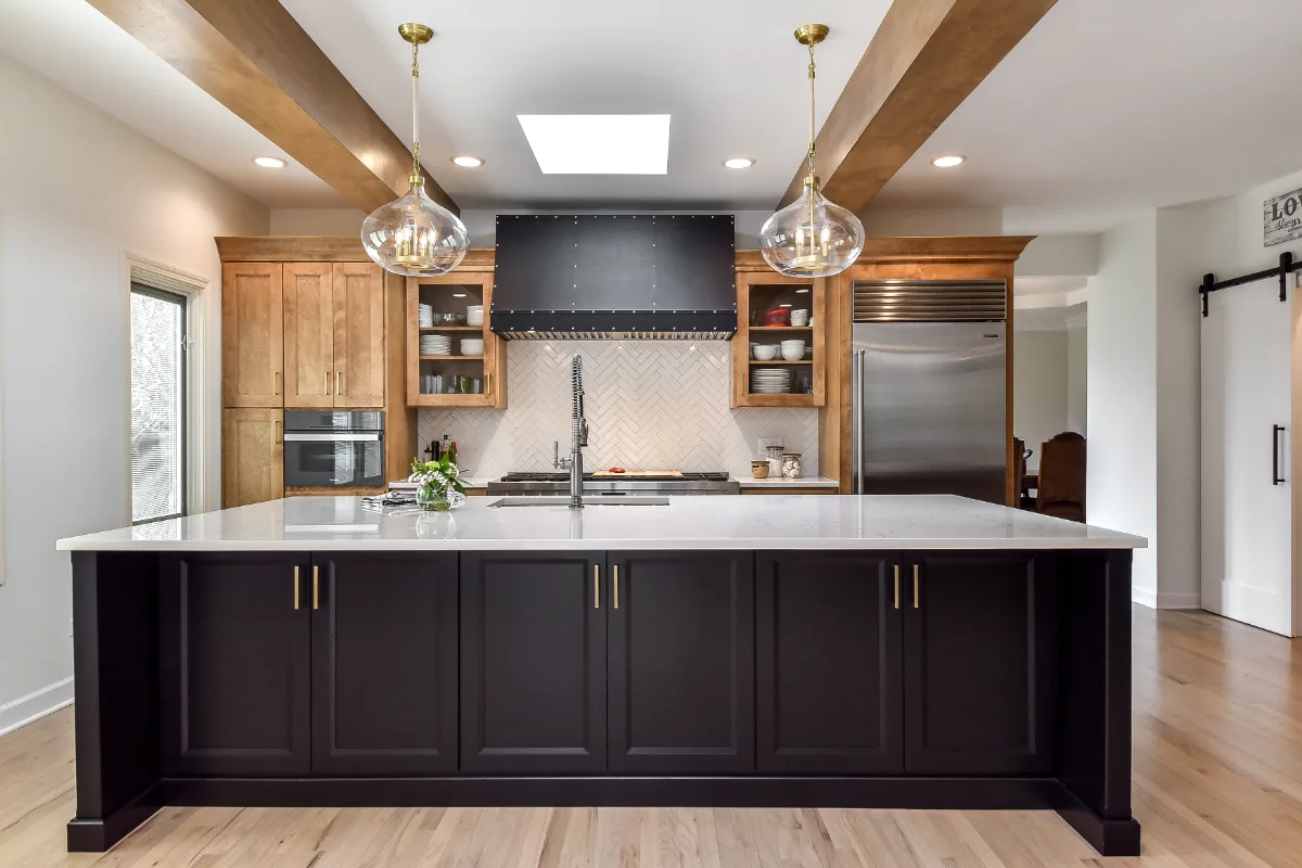 A modern-rustic kitchen in Brentwood, TN. CWP Fruitwood on Birch and Bunker Hill Black cabinetry, Cambria Charlestown Matte and Colton Polished quartz, Kohler Tournant faucet, and Ledger Stone Carbon backsplash by Sebring Design Build.