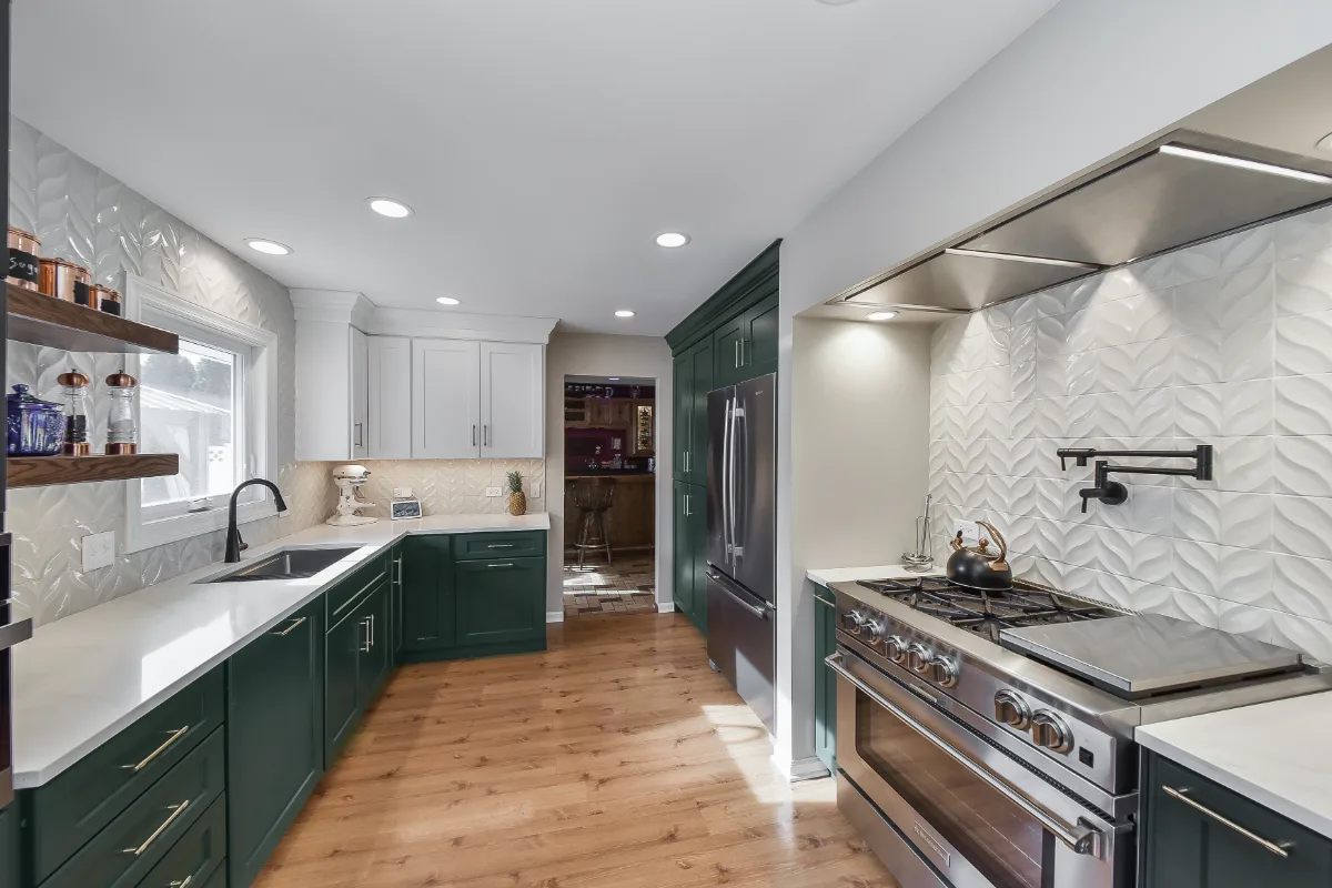 Kitchen remodel in Franklin, TN. Sebring Design Build transformed this Franklin, Tennessee galley kitchen with CWP Craftsman Square Recessed cabinetry in Soft White and Black Forest, Orion Calacatta Aria polished quartz.