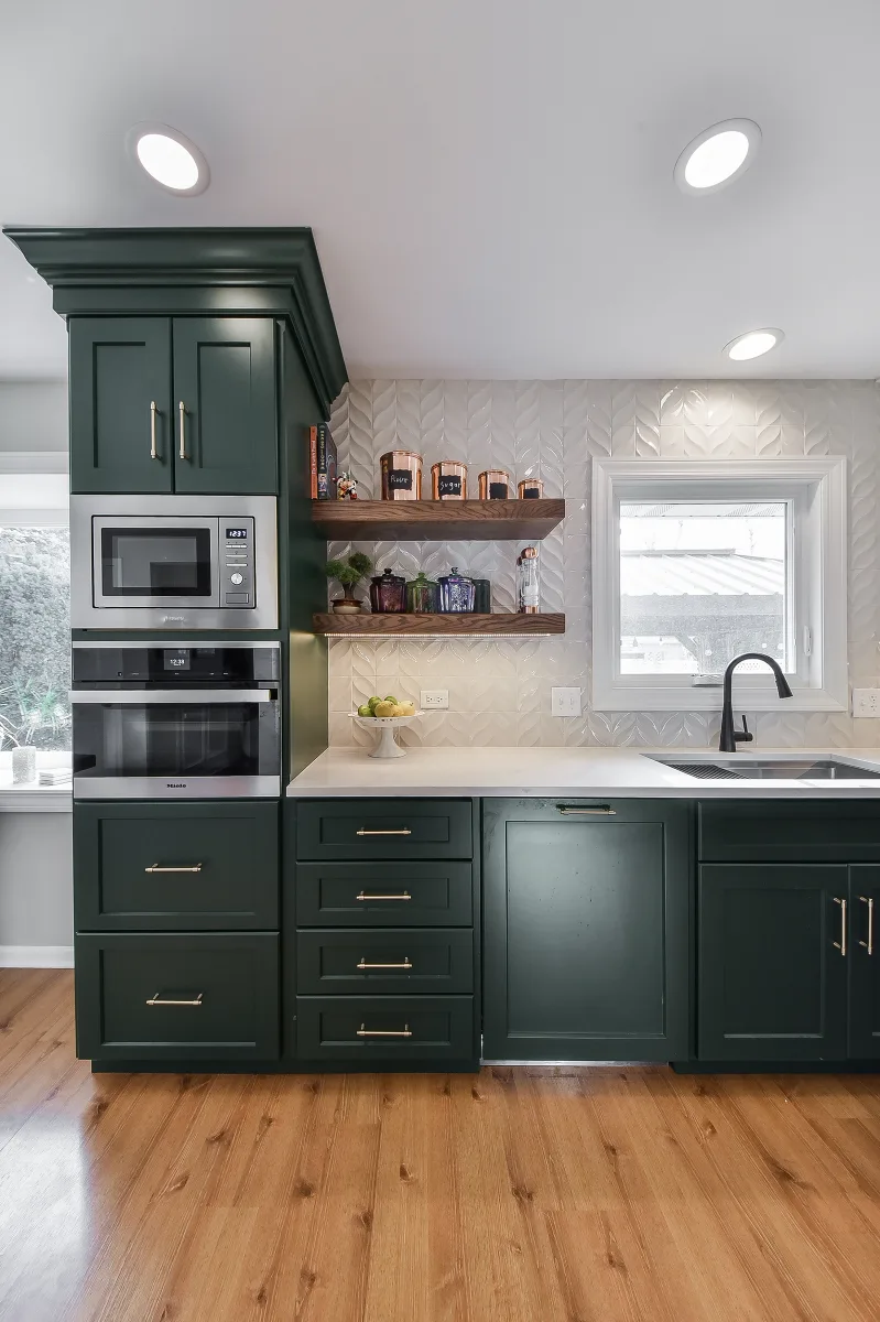 Kitchen remodel in Franklin, TN. Sebring Design Build transformed this Franklin, Tennessee galley kitchen with CWP Craftsman Square Recessed cabinetry in Soft White and Black Forest, Orion Calacatta Aria polished quartz.