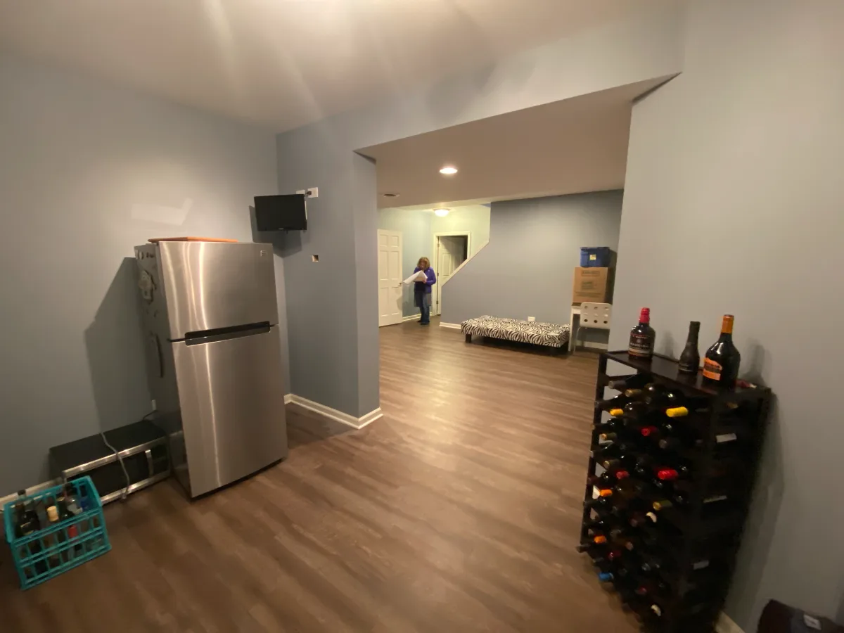 A transitional-unique basement bar with integrated wine cellar in Brentwood, TN. Bellmont Coastal Terra cabinetry, Cambria Blackpool matte quartz, and Amerock Matte Black hardware by Sebring Design Build.