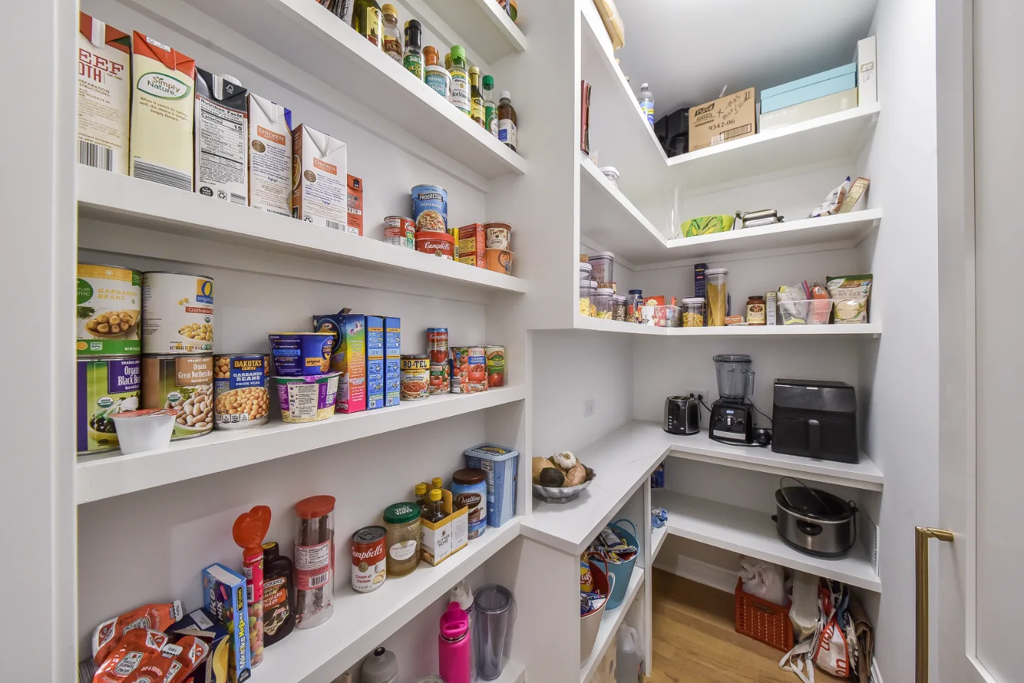 A modern-elegant pantry in Brentwood, TN. Soft White Shaker cabinetry and Corian Quartz Calcutta Natural countertops, coordinated with the kitchen remodel by Sebring Design Build.