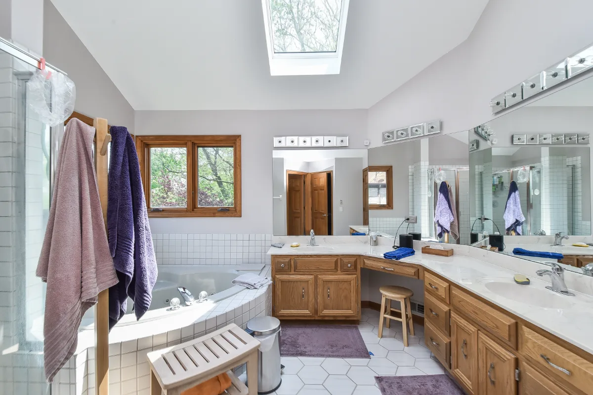 A modern-crisp primary bath in Franklin, TN. CWP Walnut Ginger Full Overlay Slab cabinetry, CaesarStone Primordia quartz, Delta Pivotal and Kohler Exhale Polished Chrome fixtures, and Virginia Tile Clash by Sebring Design Build.