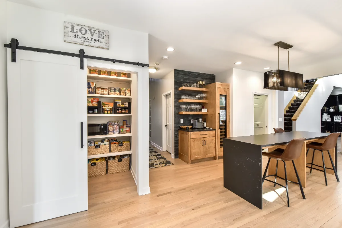 A modern-rustic walk-in pantry in Brentwood, TN. CWP Fruitwood on Birch cabinetry and Cambria Charlestown Matte quartz, coordinated with the kitchen remodel by Sebring Design Build.