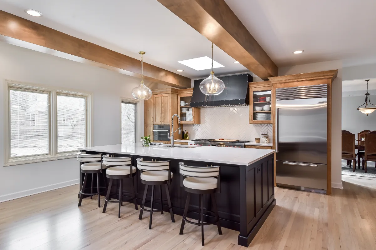 A modern-rustic kitchen in Brentwood, TN. CWP Fruitwood on Birch and Bunker Hill Black cabinetry, Cambria Charlestown Matte and Colton Polished quartz, Kohler Tournant faucet, and Ledger Stone Carbon backsplash by Sebring Design Build.