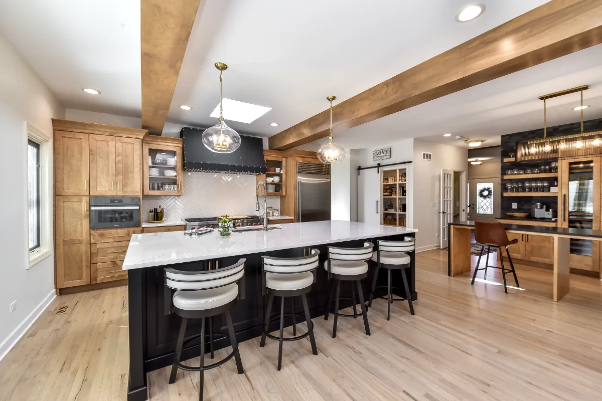 A modern-rustic kitchen in Brentwood, TN. CWP Fruitwood on Birch and Bunker Hill Black cabinetry, Cambria Charlestown Matte and Colton Polished quartz, Kohler Tournant faucet, and Ledger Stone Carbon backsplash by Sebring Design Build.