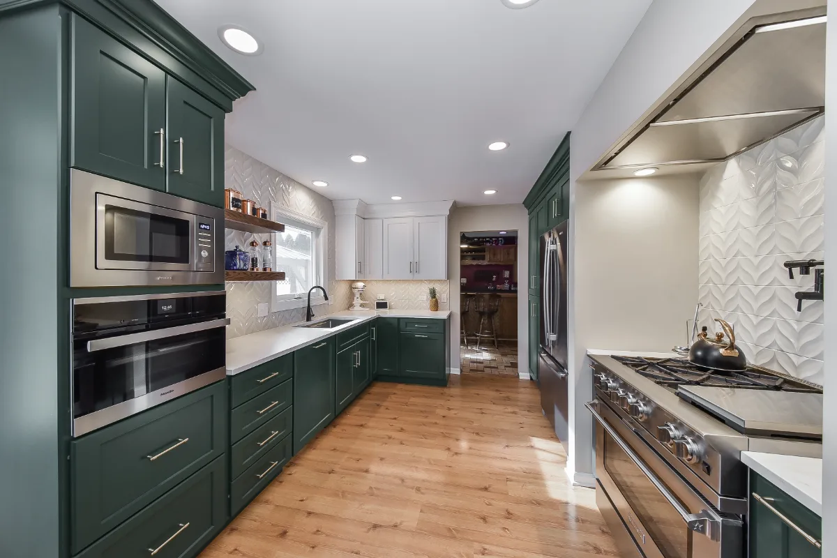 Kitchen remodel in Franklin, TN. Sebring Design Build transformed this Franklin, Tennessee galley kitchen with CWP Craftsman Square Recessed cabinetry in Soft White and Black Forest, Orion Calacatta Aria polished quartz.