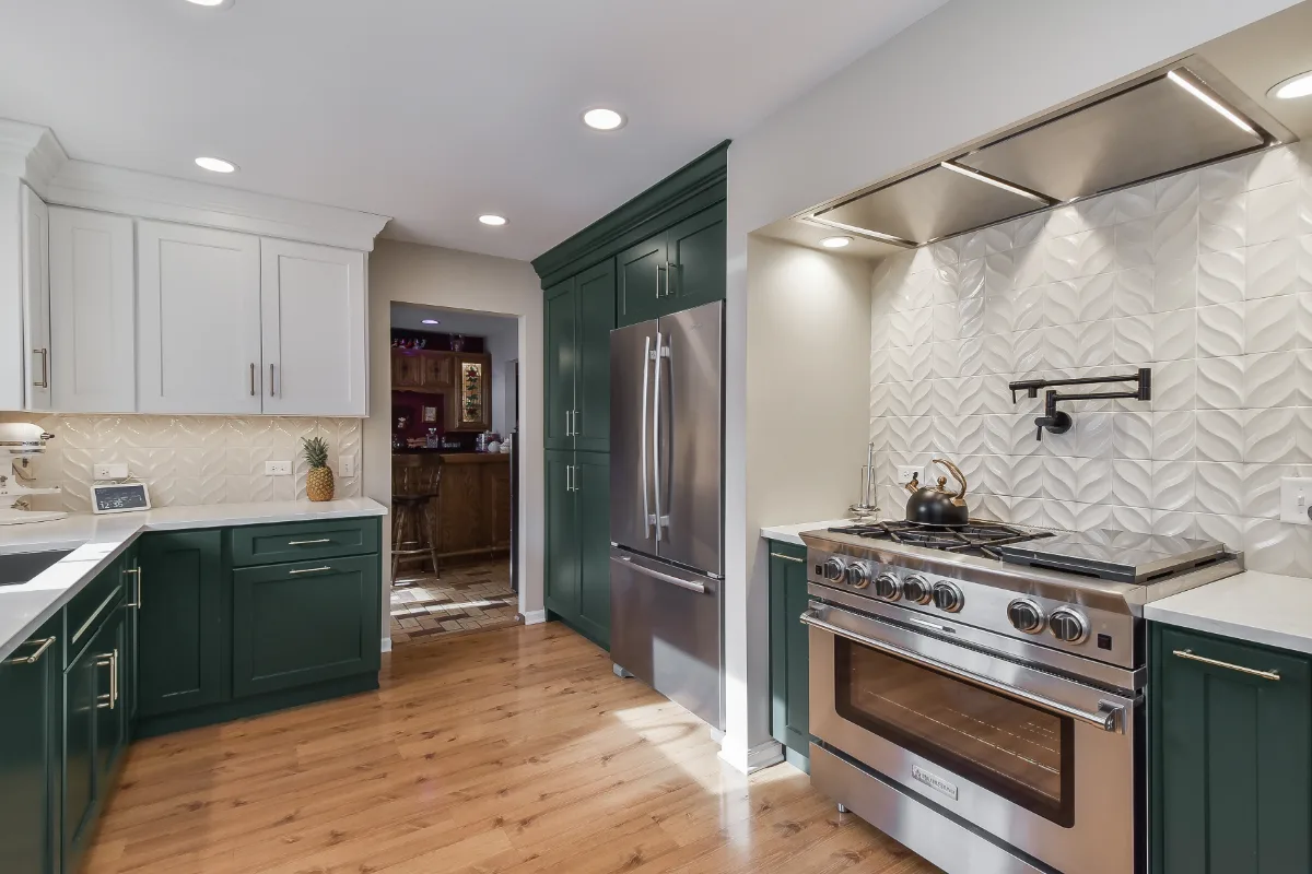 Kitchen remodel in Franklin, TN. Sebring Design Build transformed this Franklin, Tennessee galley kitchen with CWP Craftsman Square Recessed cabinetry in Soft White and Black Forest, Orion Calacatta Aria polished quartz.