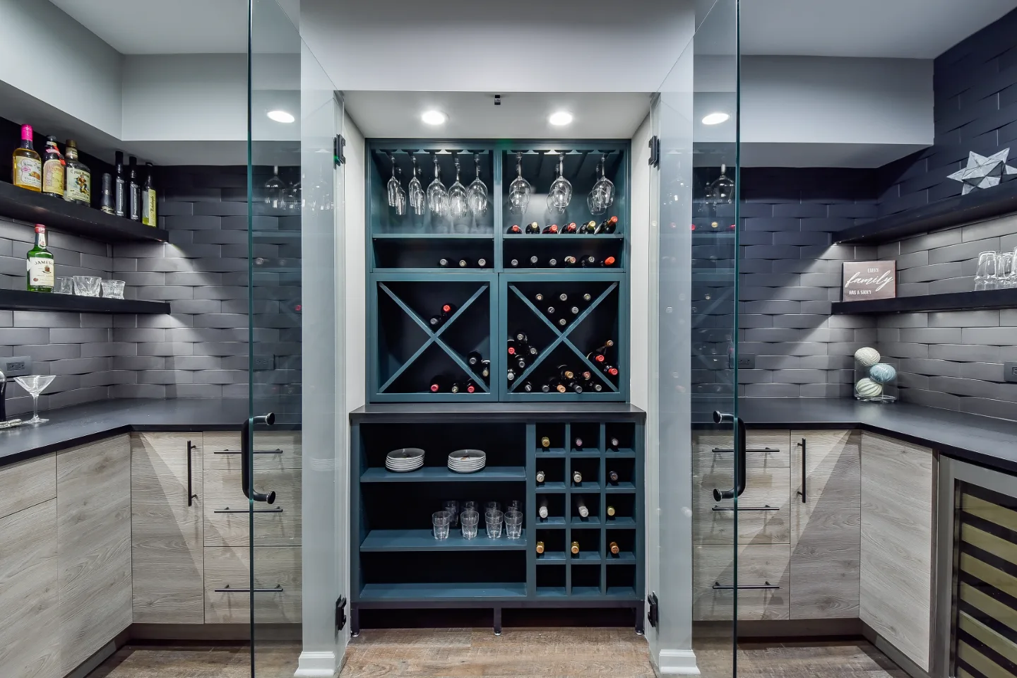 A transitional-unique basement bar with integrated wine cellar in Brentwood, TN. Bellmont Coastal Terra cabinetry, Cambria Blackpool matte quartz, and Amerock Matte Black hardware by Sebring Design Build.