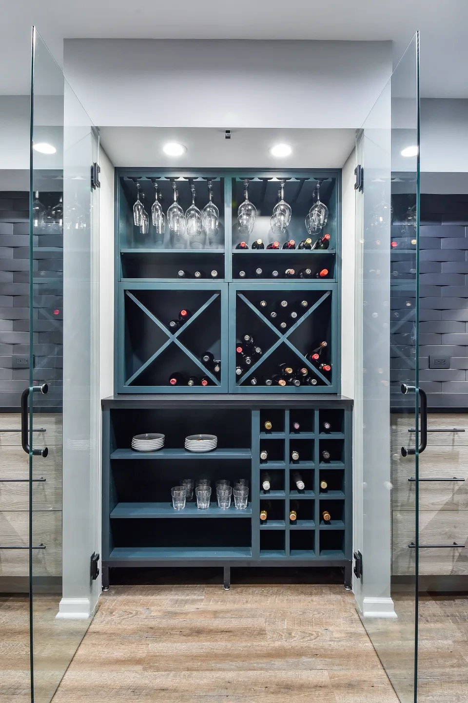 A transitional-unique basement bar with integrated wine cellar in Brentwood, TN. Bellmont Coastal Terra cabinetry, Cambria Blackpool matte quartz, and Amerock Matte Black hardware by Sebring Design Build.