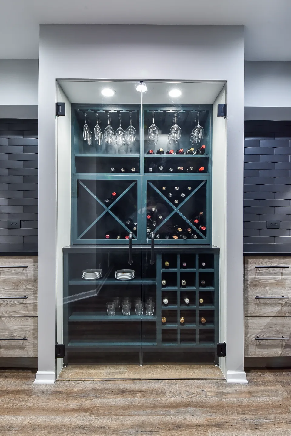 A transitional-unique basement bar with integrated wine cellar in Brentwood, TN. Bellmont Coastal Terra cabinetry, Cambria Blackpool matte quartz, and Amerock Matte Black hardware by Sebring Design Build.