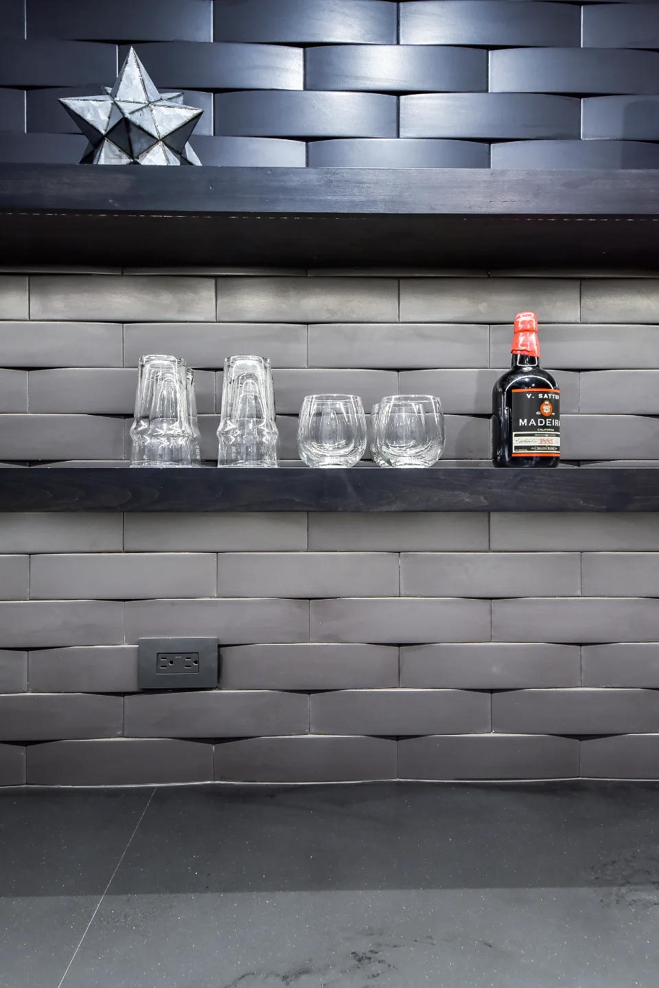A transitional-unique basement bar with integrated wine cellar in Brentwood, TN. Bellmont Coastal Terra cabinetry, Cambria Blackpool matte quartz, and Amerock Matte Black hardware by Sebring Design Build.