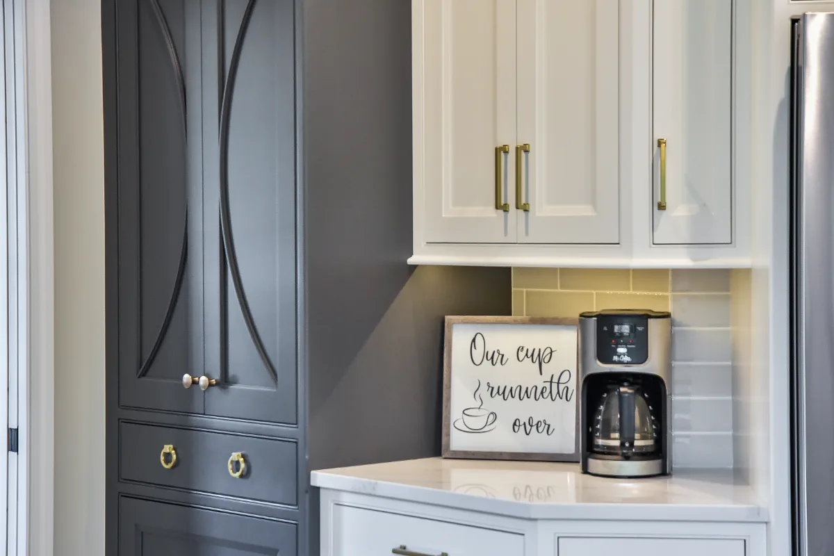 A transitional-warm kitchen in Brentwood, TN. CWP Snowbound and Urban Bronze Beaded Inset cabinetry, Orion Calacatta Aria quartz, Black Walnut end-grain island top, and Sonoma Stellar Metro Gray backsplash by Sebring Design Build.