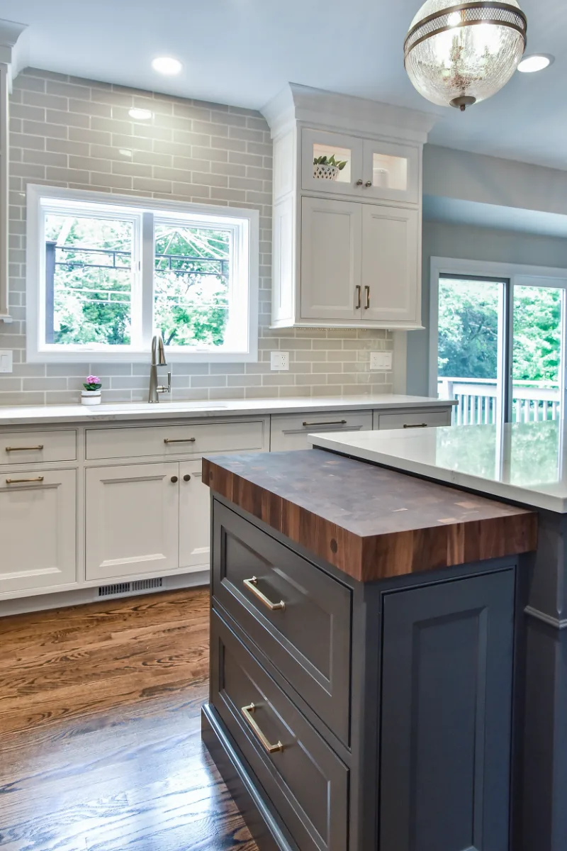 A transitional-warm kitchen in Brentwood, TN. CWP Snowbound and Urban Bronze Beaded Inset cabinetry, Orion Calacatta Aria quartz, Black Walnut end-grain island top, and Sonoma Stellar Metro Gray backsplash by Sebring Design Build.