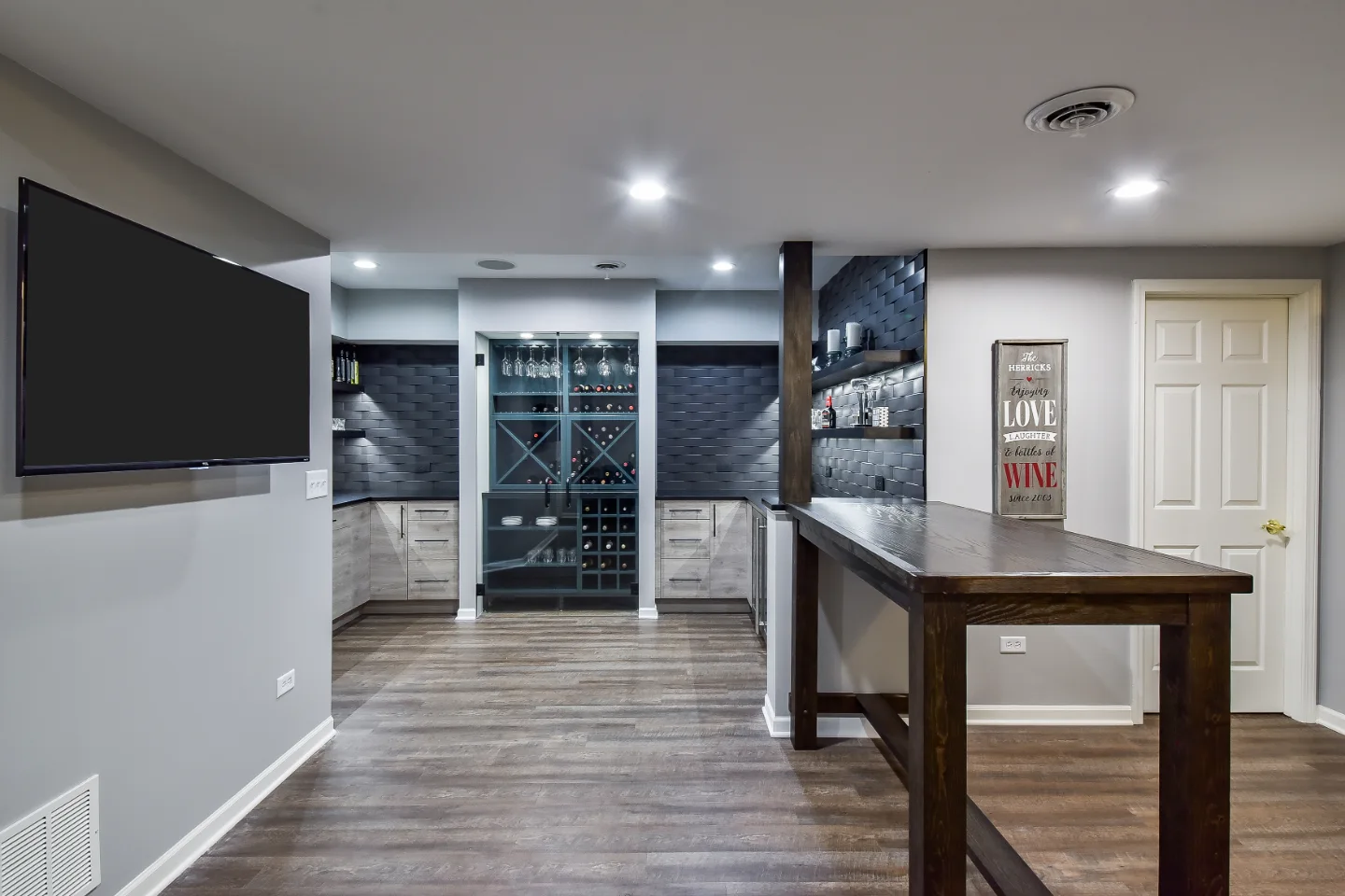 A transitional-unique basement remodel in Brentwood, TN. Bellmont Coastal Terra and Olympic Seaside cabinetry, Cambria Blackpool matte quartz, and Amerock Matte Black hardware by Sebring Design Build.