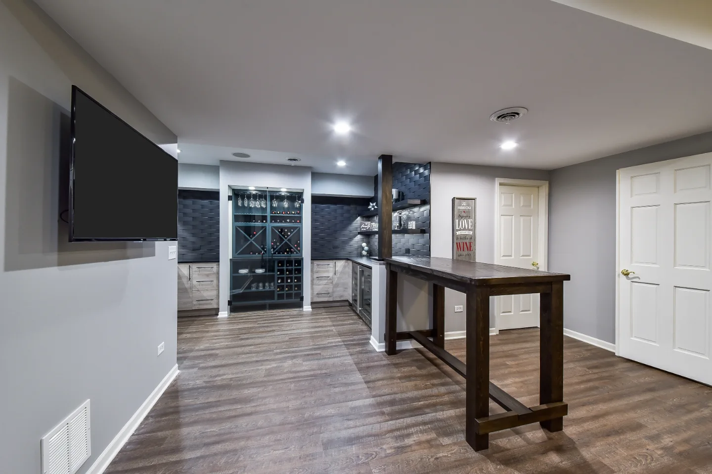 A transitional-unique basement remodel in Brentwood, TN. Bellmont Coastal Terra and Olympic Seaside cabinetry, Cambria Blackpool matte quartz, and Amerock Matte Black hardware by Sebring Design Build.