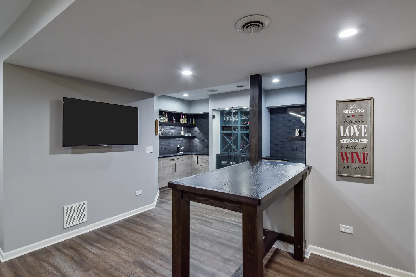 A transitional-unique basement remodel in Brentwood, TN. Bellmont Coastal Terra and Olympic Seaside cabinetry, Cambria Blackpool matte quartz, and Amerock Matte Black hardware by Sebring Design Build.