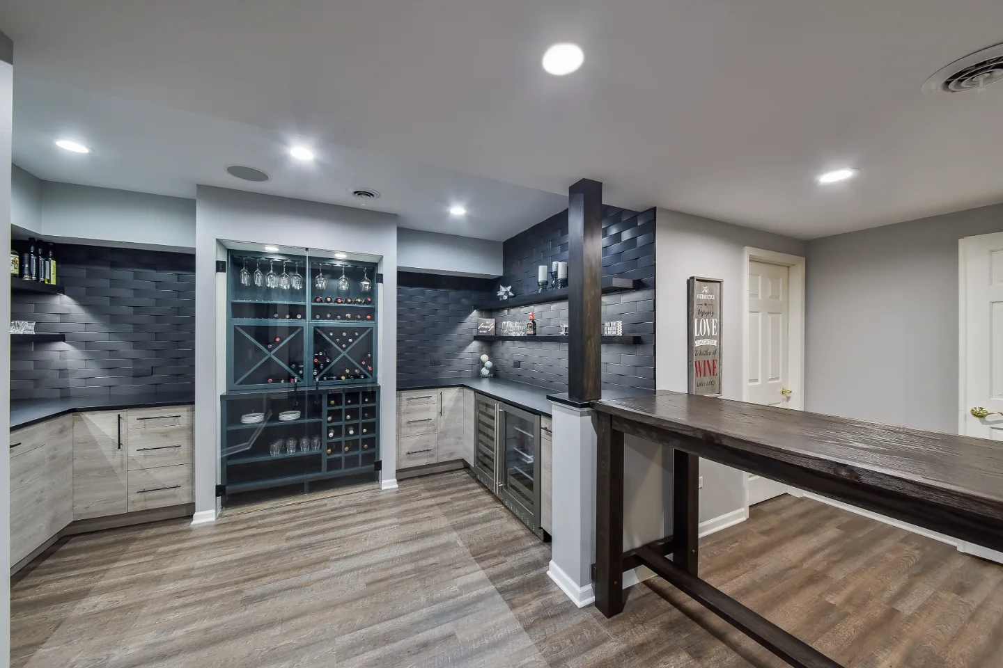 A transitional-unique basement remodel in Brentwood, TN. Bellmont Coastal Terra and Olympic Seaside cabinetry, Cambria Blackpool matte quartz, and Amerock Matte Black hardware by Sebring Design Build.