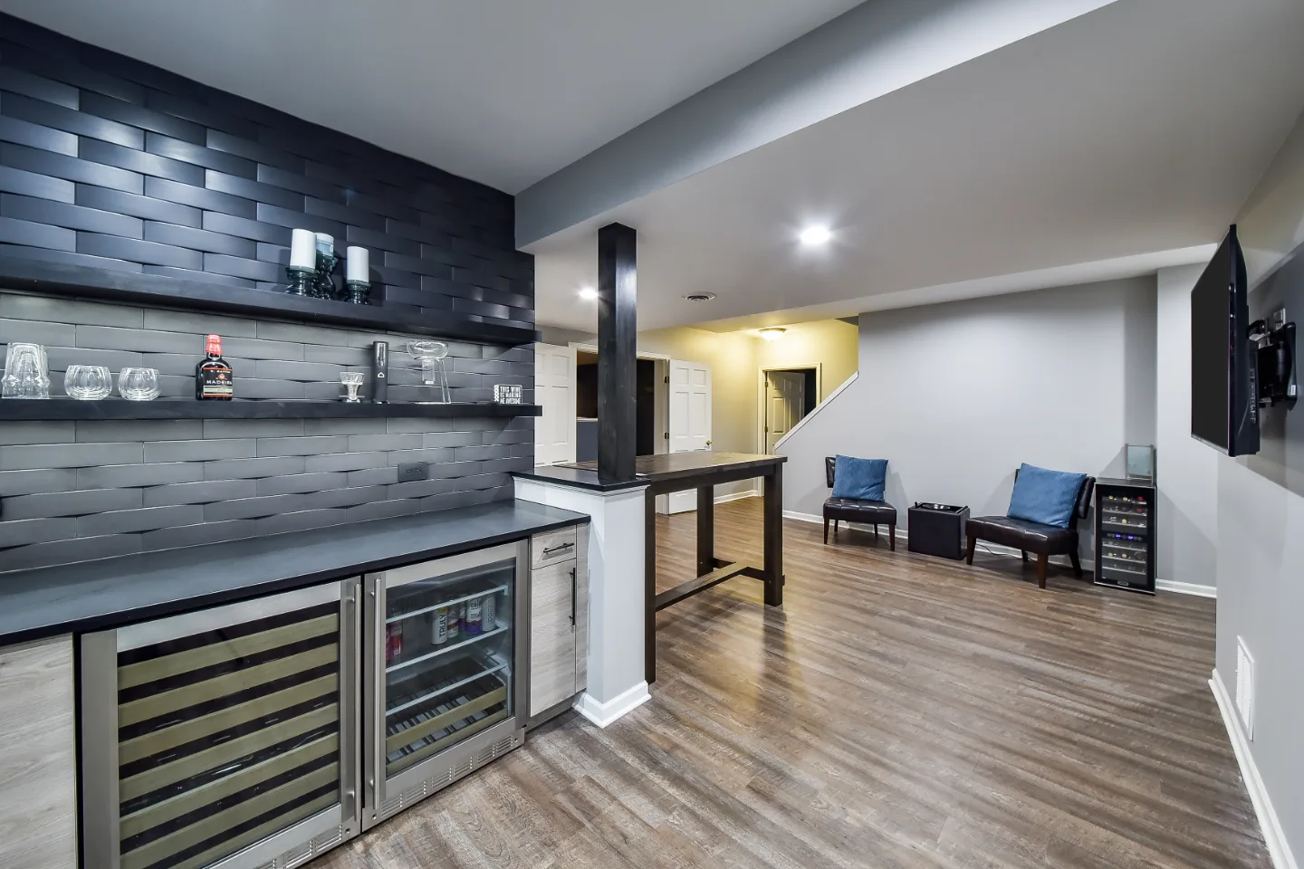 A transitional-unique basement remodel in Brentwood, TN. Bellmont Coastal Terra and Olympic Seaside cabinetry, Cambria Blackpool matte quartz, and Amerock Matte Black hardware by Sebring Design Build.