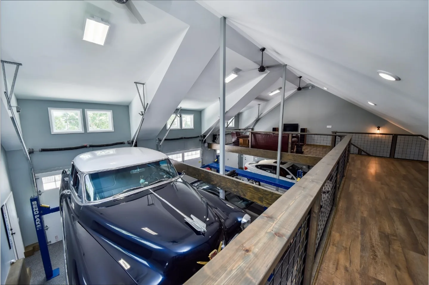 A rustic-organic custom garage in Franklin, TN with lift systems and classic car storage by Sebring Design Build. Specs pending photo verification.