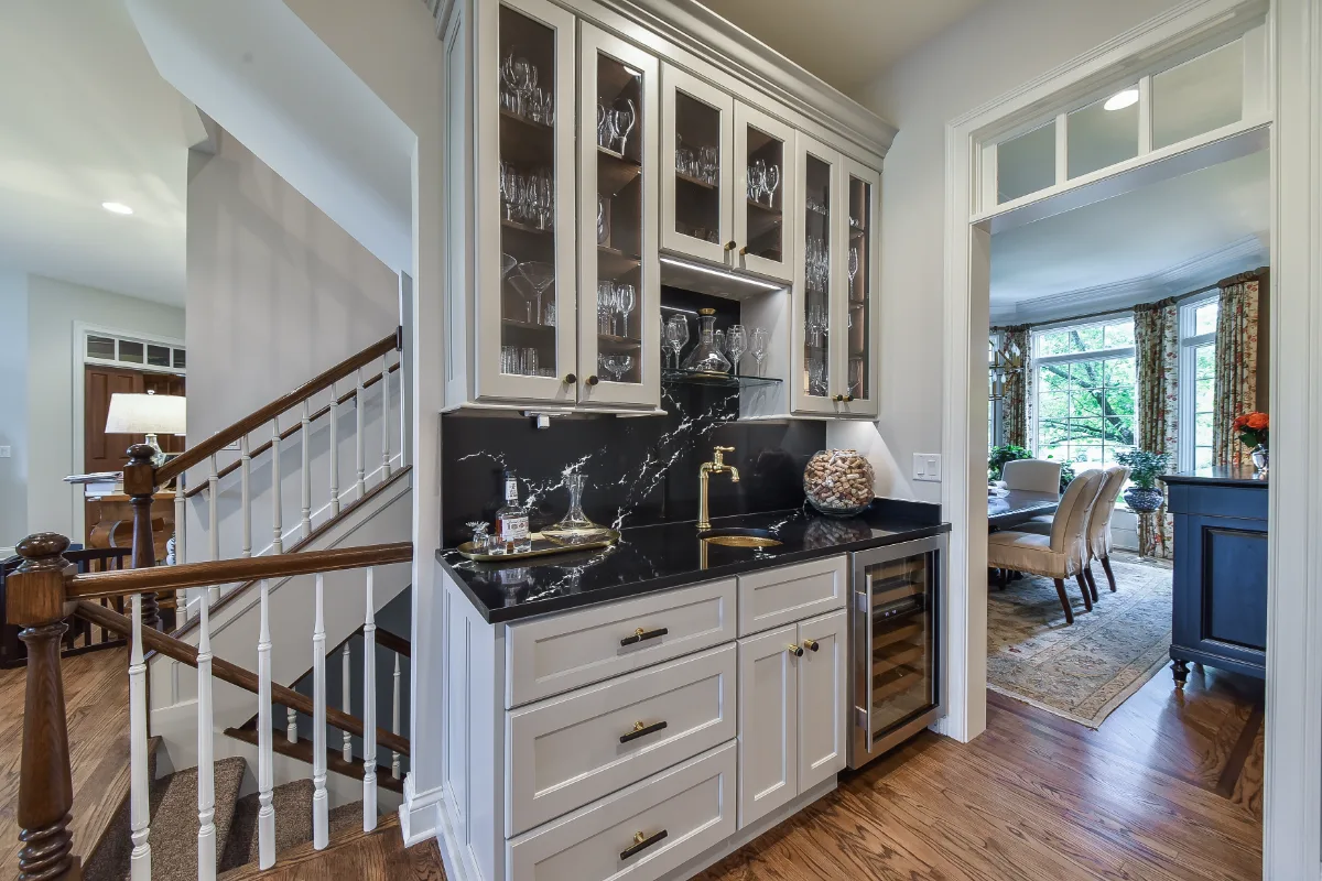 A transitional-elegant multi-room remodel in Brentwood, TN. Grand kitchen with CWP Fawn Brindle cabinetry, CaesarStone Statuario Nuvo, Kohler Artifacts Polished Nickel, and a brass powder room showstopper by Sebring Design Build.