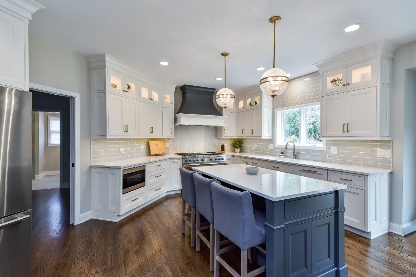A transitional-warm kitchen in Brentwood, TN. CWP Snowbound and Urban Bronze Beaded Inset cabinetry, Orion Calacatta Aria quartz, Black Walnut end-grain island top, and Sonoma Stellar Metro Gray backsplash by Sebring Design Build.