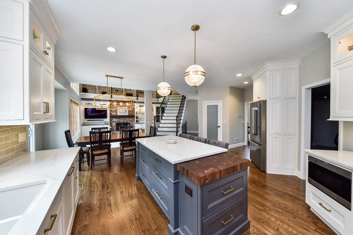 A transitional-warm kitchen in Brentwood, TN. CWP Snowbound and Urban Bronze Beaded Inset cabinetry, Orion Calacatta Aria quartz, Black Walnut end-grain island top, and Sonoma Stellar Metro Gray backsplash by Sebring Design Build.