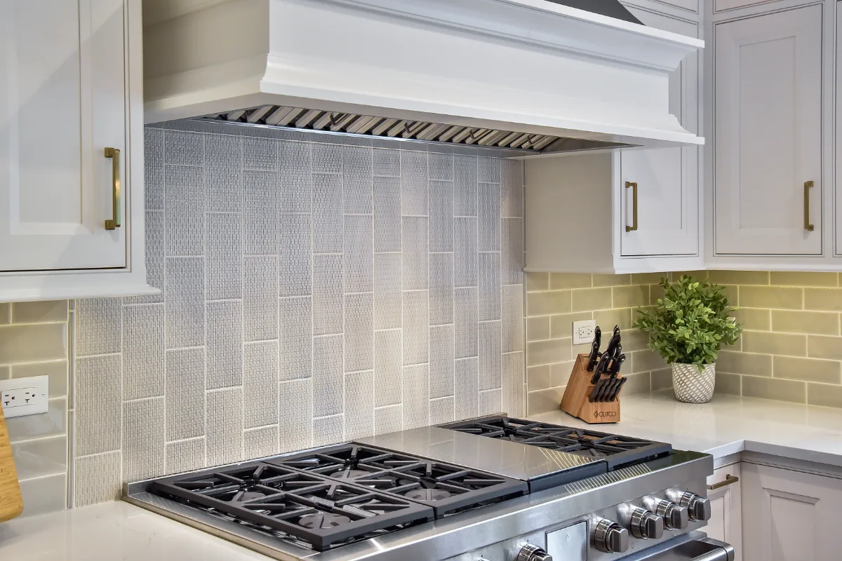 A transitional-warm kitchen in Brentwood, TN. CWP Snowbound and Urban Bronze Beaded Inset cabinetry, Orion Calacatta Aria quartz, Black Walnut end-grain island top, and Sonoma Stellar Metro Gray backsplash by Sebring Design Build.