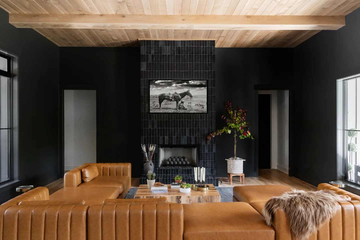 A unique-luxurious living room in Columbia, TN with natural wood tones, exposed brick archway, and warm contemporary design by Sebring Design Build. Specs pending photo verification.