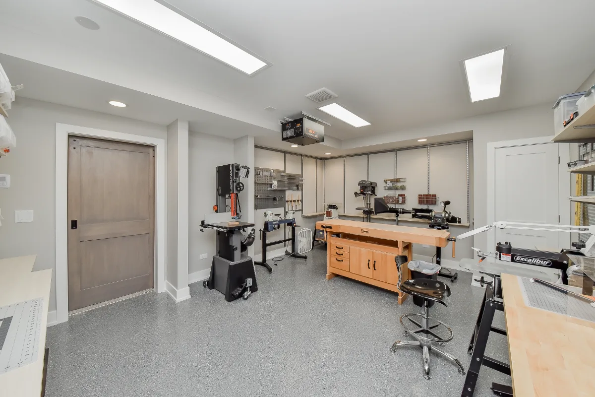 Workshop remodel in Franklin, TN. Sebring Design Build finished this Franklin basement workshop with a concrete floor finish built for real work: durable, honest to the space's purpose.