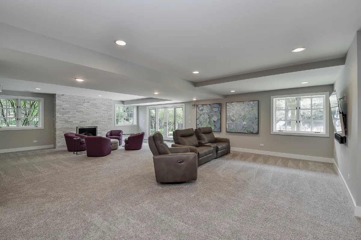 A functional-modern basement remodel in Franklin, TN with a guest bath, wet bar, workshop, and gym. Cambria Devon quartz and Moen Chrome fixtures by Sebring Design Build.