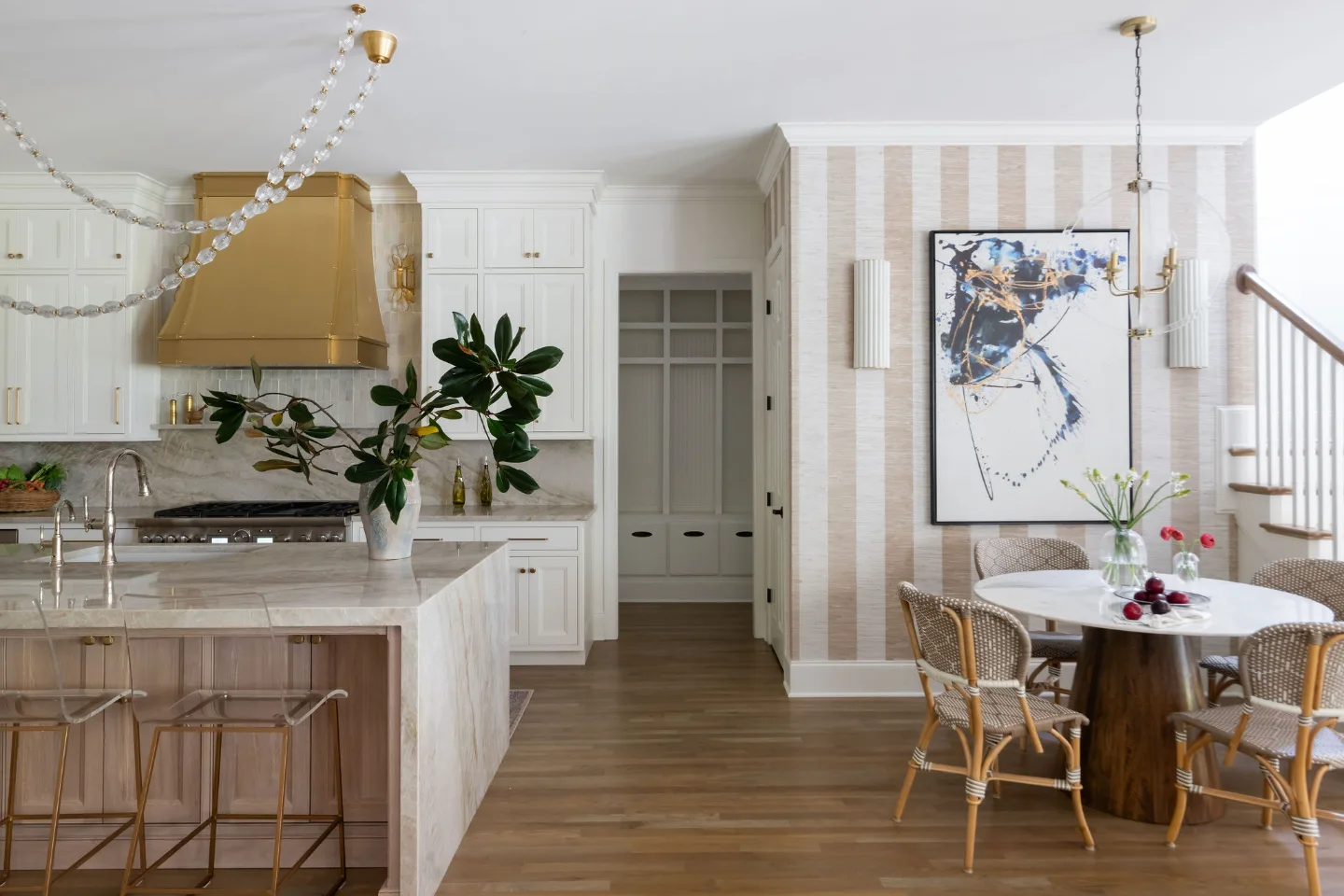 A modern-warm kitchen in Westhaven, Franklin TN 37064. CWP Dune and Tarragon cabinetry, custom brushed brass range hood, Calcutta Castana quartz, Natural White Zellige backsplash, and Patina Siren butler's pantry by Sebring Design Build.