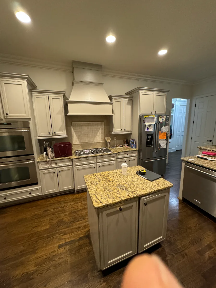 A modern-warm kitchen in Westhaven, Franklin TN 37064. CWP Dune and Tarragon cabinetry, custom brushed brass range hood, Calcutta Castana quartz, Natural White Zellige backsplash, and Patina Siren butler's pantry by Sebring Design Build.