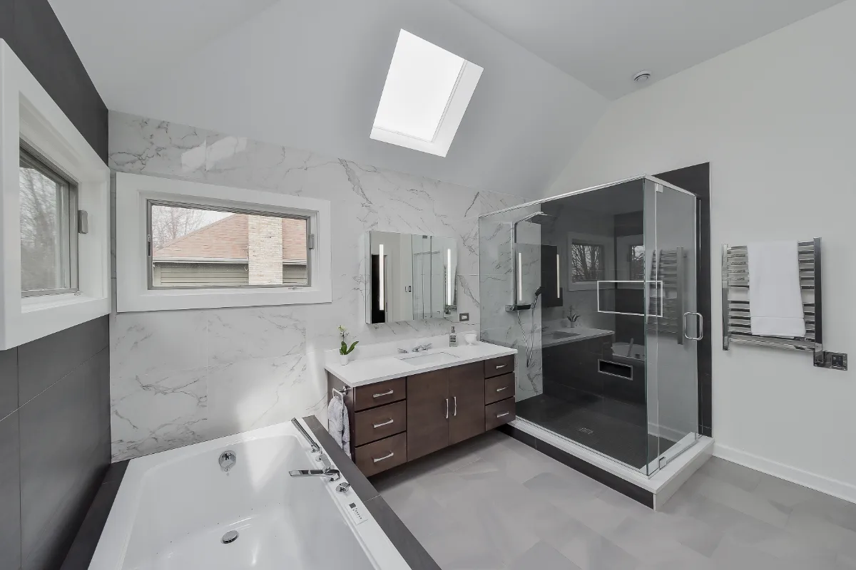 A modern-crisp primary bath remodel in Brentwood, TN. Wellborn Barcelona Oak Drift cabinetry, Orion Absolute White quartz, Atlas Concorde Calacatta Extra vanity wall, and Polished Chrome fixtures by Sebring Design Build.