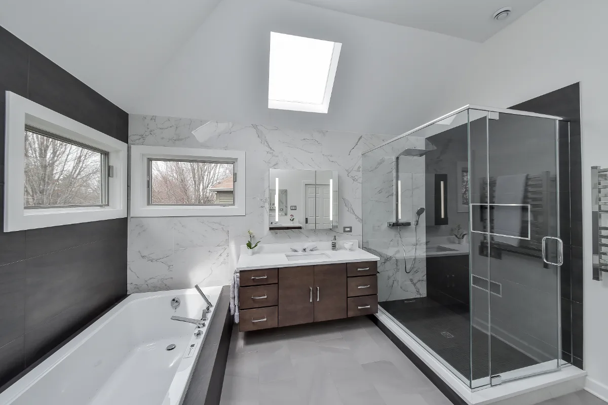 A modern-crisp primary bath remodel in Brentwood, TN. Wellborn Barcelona Oak Drift cabinetry, Orion Absolute White quartz, Atlas Concorde Calacatta Extra vanity wall, and Polished Chrome fixtures by Sebring Design Build.