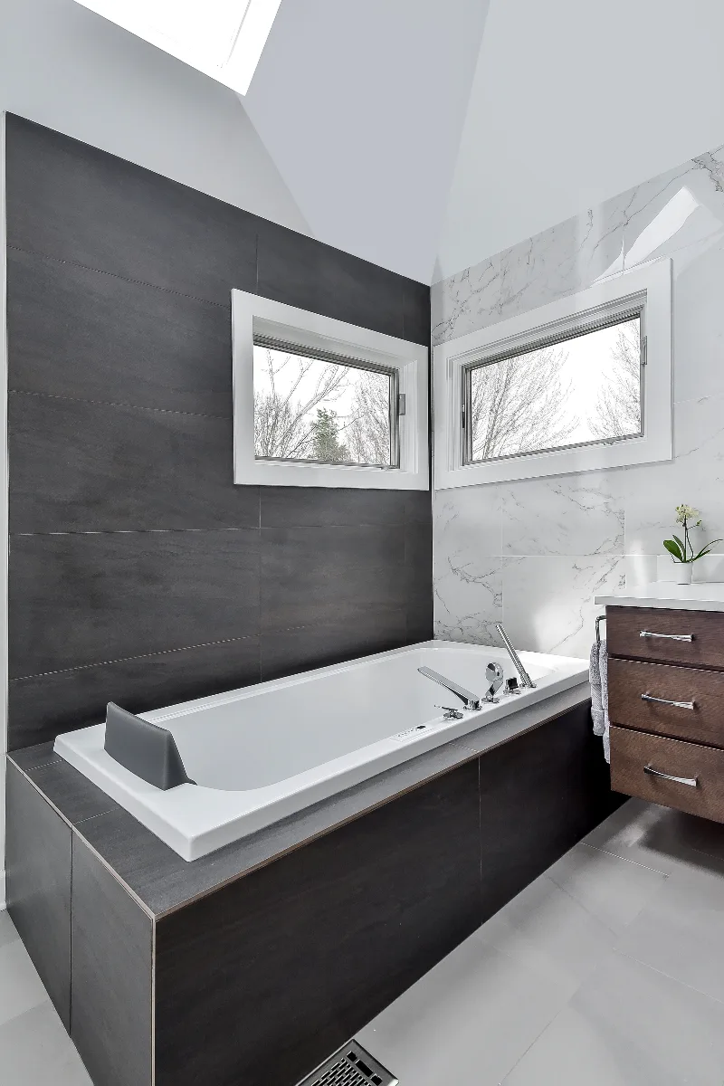 A modern-crisp primary bath remodel in Brentwood, TN. Wellborn Barcelona Oak Drift cabinetry, Orion Absolute White quartz, Atlas Concorde Calacatta Extra vanity wall, and Polished Chrome fixtures by Sebring Design Build.