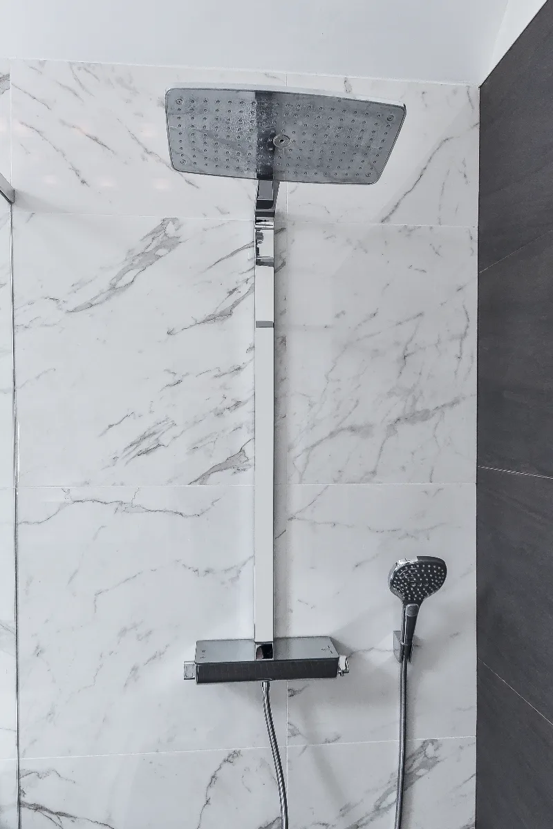 A modern-crisp primary bath remodel in Brentwood, TN. Wellborn Barcelona Oak Drift cabinetry, Orion Absolute White quartz, Atlas Concorde Calacatta Extra vanity wall, and Polished Chrome fixtures by Sebring Design Build.