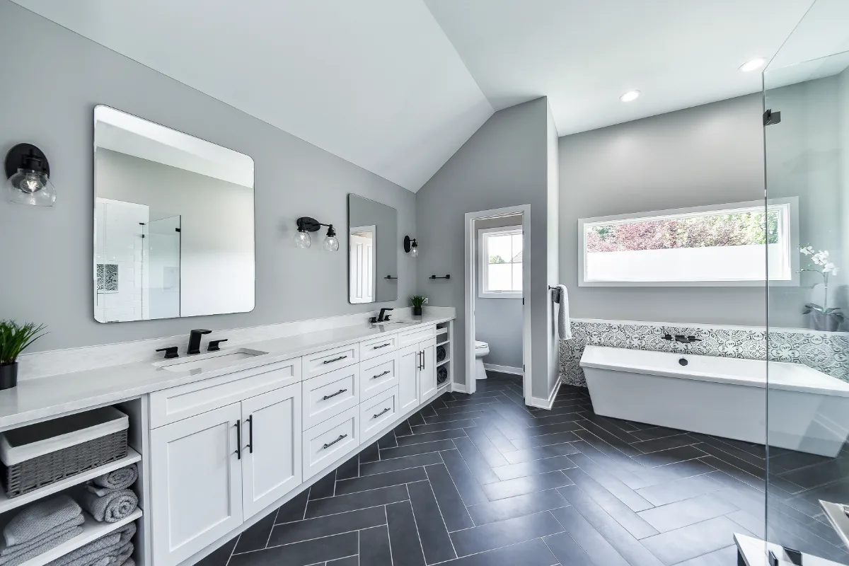 A modern-black-white primary bath remodel in Franklin, TN. Bellmont 1600 Studio White cabinetry, Cambria Deligatie quartz, Kohler Pivotal Matte Black, MTI Andrea tub, and MSI Kenzzi Paloma tile by Sebring Design Build.