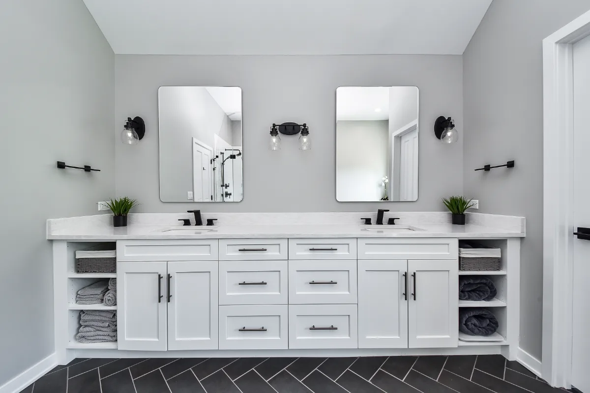 A modern-black-white primary bath remodel in Franklin, TN. Bellmont 1600 Studio White cabinetry, Cambria Deligatie quartz, Kohler Pivotal Matte Black, MTI Andrea tub, and MSI Kenzzi Paloma tile by Sebring Design Build.