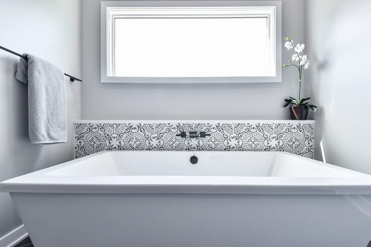 A modern-black-white primary bath remodel in Franklin, TN. Bellmont 1600 Studio White cabinetry, Cambria Deligatie quartz, Kohler Pivotal Matte Black, MTI Andrea tub, and MSI Kenzzi Paloma tile by Sebring Design Build.