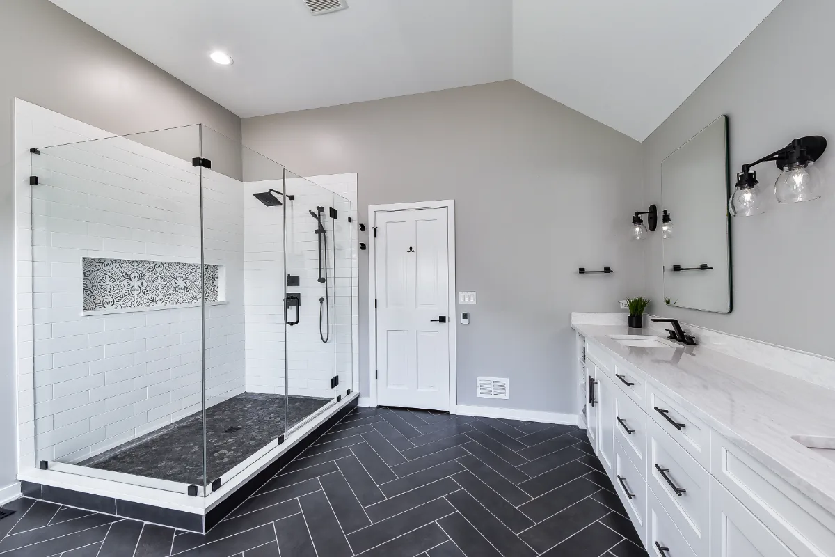 A modern-black-white primary bath remodel in Franklin, TN. Bellmont 1600 Studio White cabinetry, Cambria Deligatie quartz, Kohler Pivotal Matte Black, MTI Andrea tub, and MSI Kenzzi Paloma tile by Sebring Design Build.