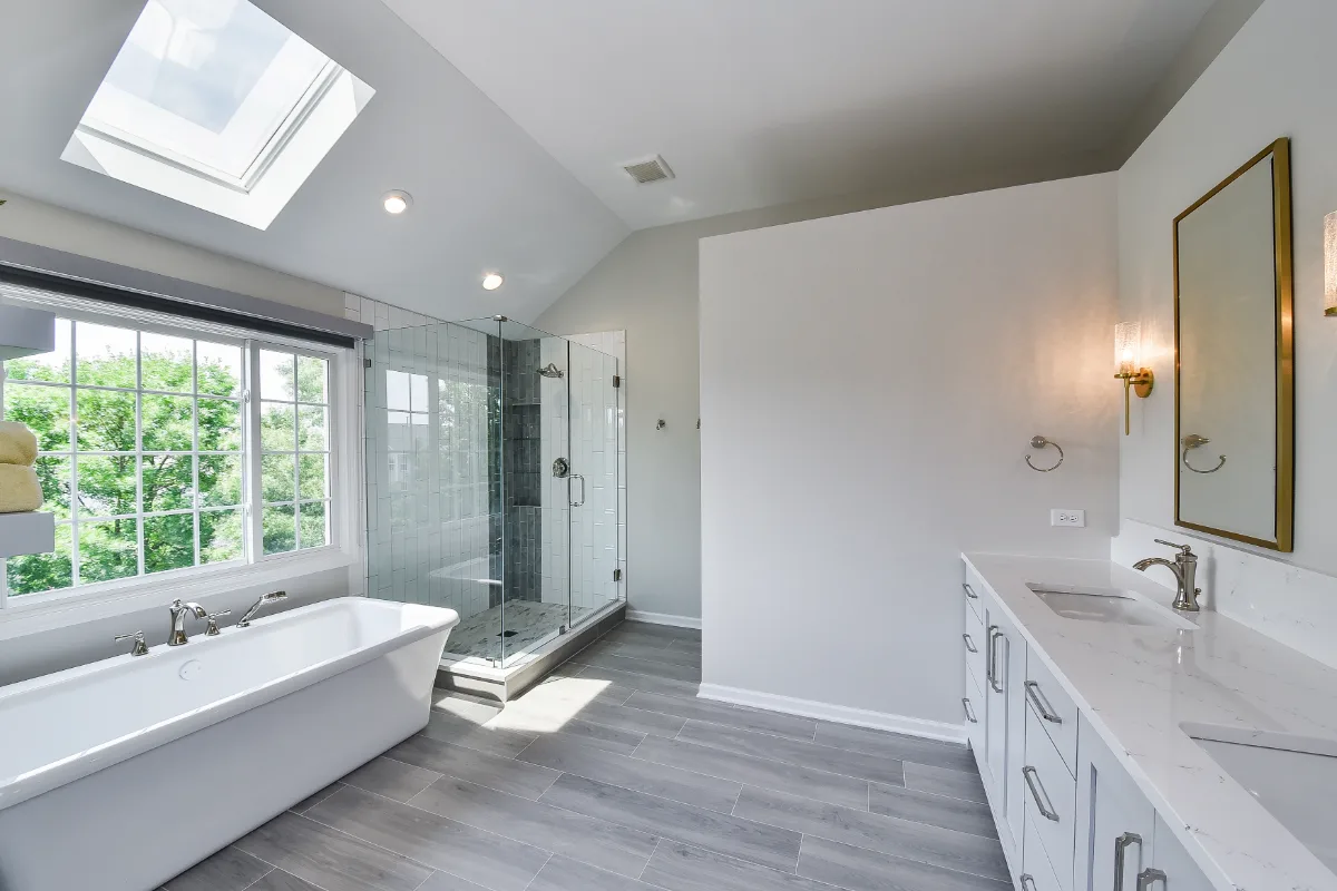 A modern-unique primary bath remodel in Brentwood, TN. Pearl cabinetry, Hanstone Tranquility quartz, MTI Rectangle soaking tub, Lunada Bay Aura Pearl accent tile, and Moen Polished Nickel by Sebring Design Build.