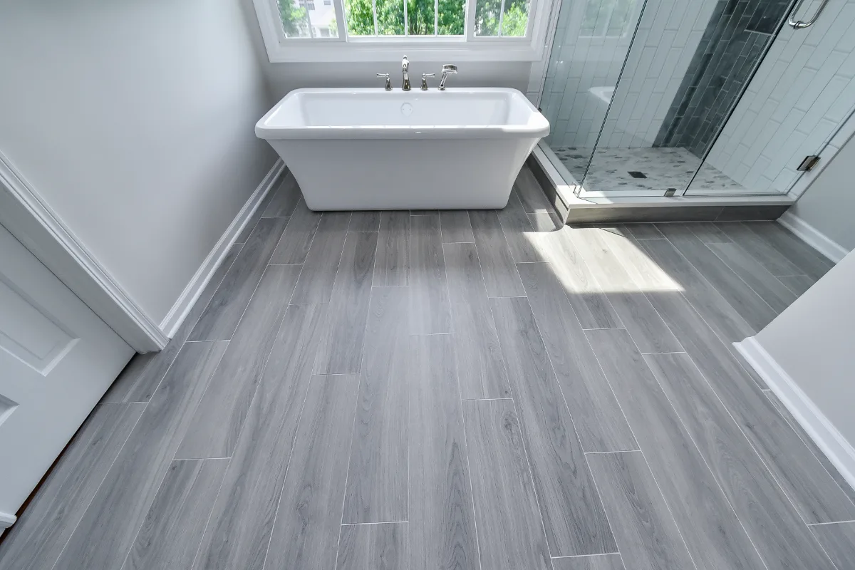 A modern-unique primary bath remodel in Brentwood, TN. Pearl cabinetry, Hanstone Tranquility quartz, MTI Rectangle soaking tub, Lunada Bay Aura Pearl accent tile, and Moen Polished Nickel by Sebring Design Build.