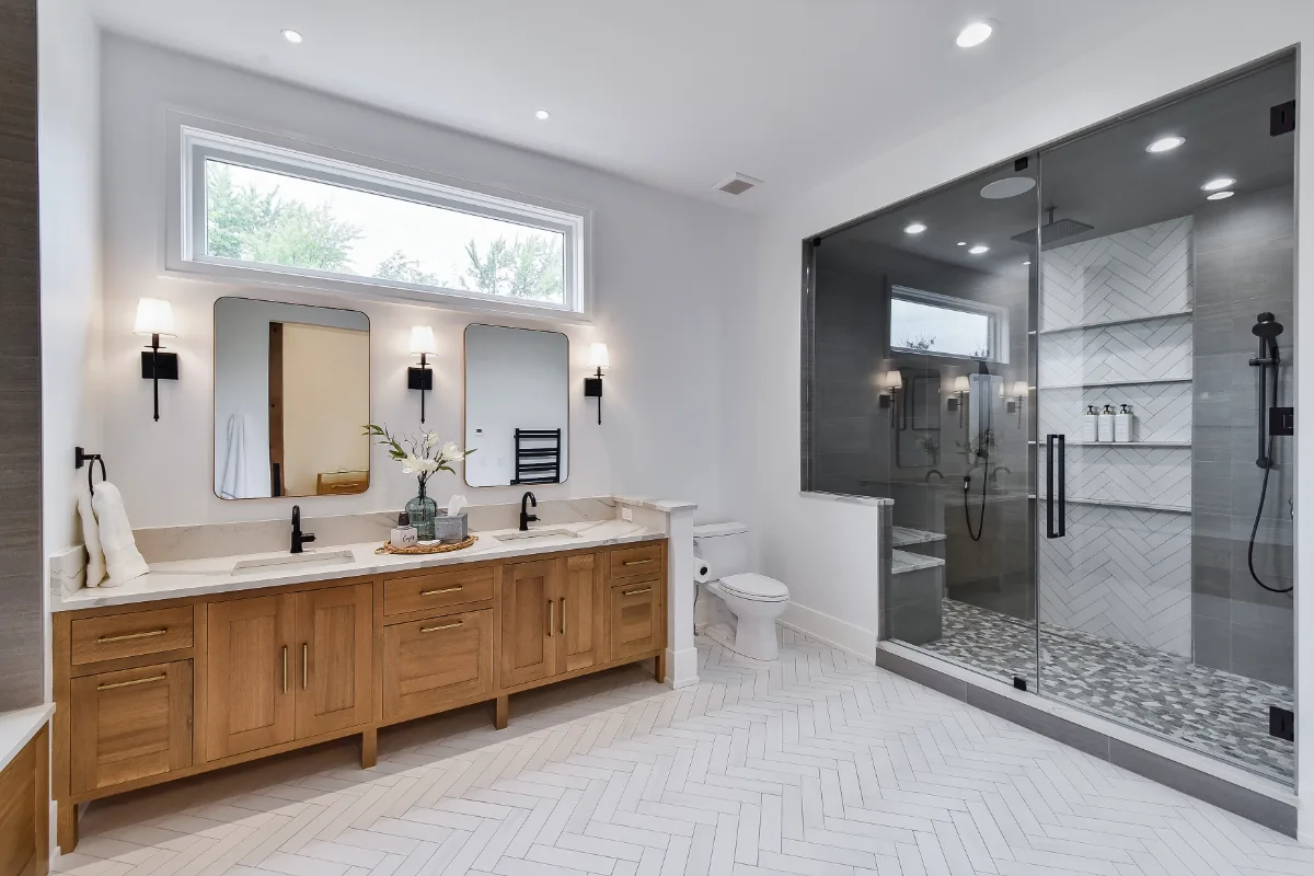 A transitional-elegant primary bath remodel in Franklin, TN. White Oak Sage cabinetry, Cambria Brittanicca Warm quartz, MTI Andrea soaking tub, and Dolomiti tile by Sebring Design Build.