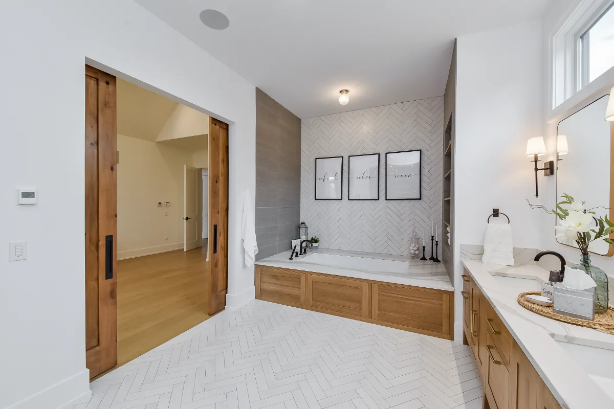A transitional-elegant primary bath remodel in Franklin, TN. White Oak Sage cabinetry, Cambria Brittanicca Warm quartz, MTI Andrea soaking tub, and Dolomiti tile by Sebring Design Build.