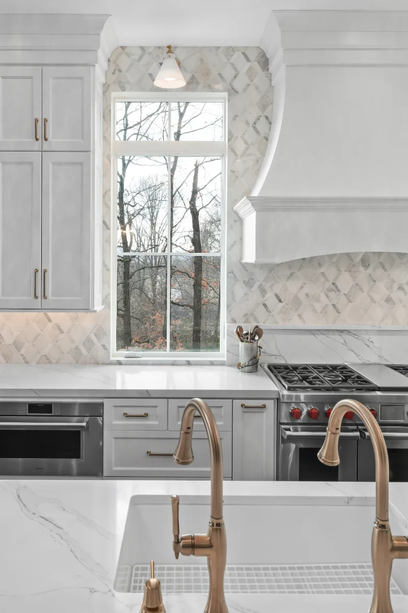 Kitchen remodel in Governors Club, Brentwood TN. Elegant, light palette with custom cabinetry and stone countertops by Sebring Design Build.
