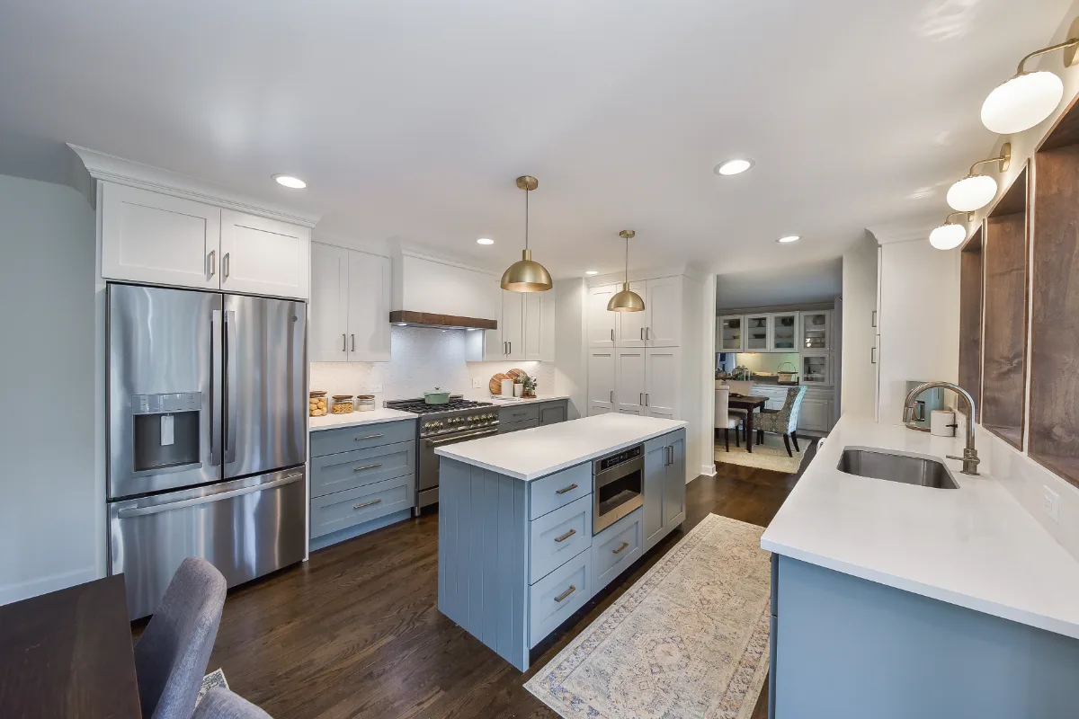Kitchen remodel in Brentwood, TN with blue and white cabinetry and gold accents. A refreshing interior kitchen transformation by Sebring Design Build.