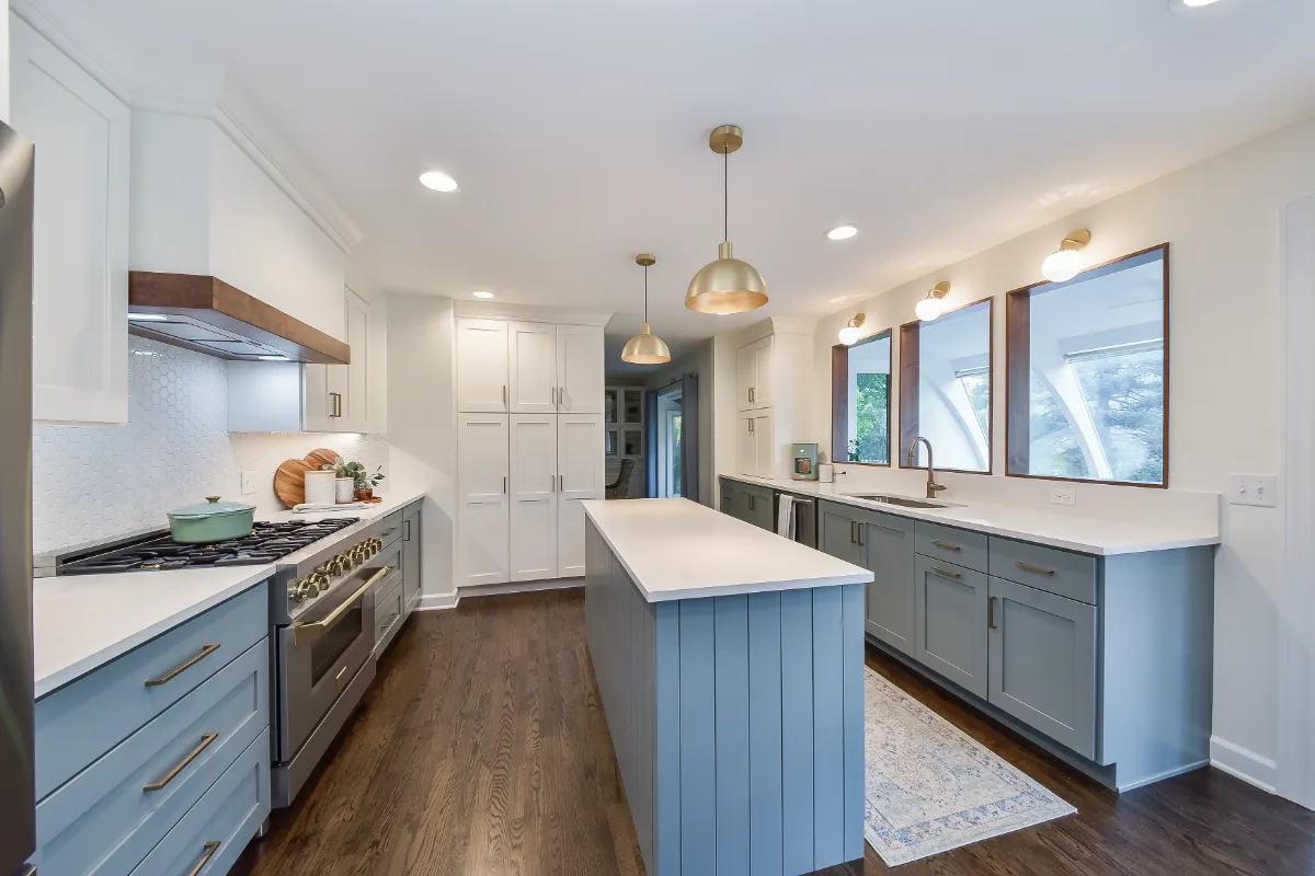 Kitchen remodel in Brentwood, TN with blue and white cabinetry and gold accents. A refreshing interior kitchen transformation by Sebring Design Build.