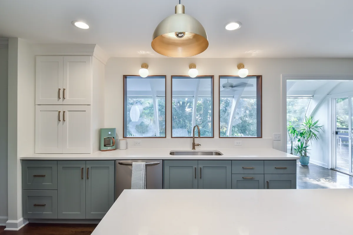 Kitchen remodel in Brentwood, TN with blue and white cabinetry and gold accents. A refreshing interior kitchen transformation by Sebring Design Build.
