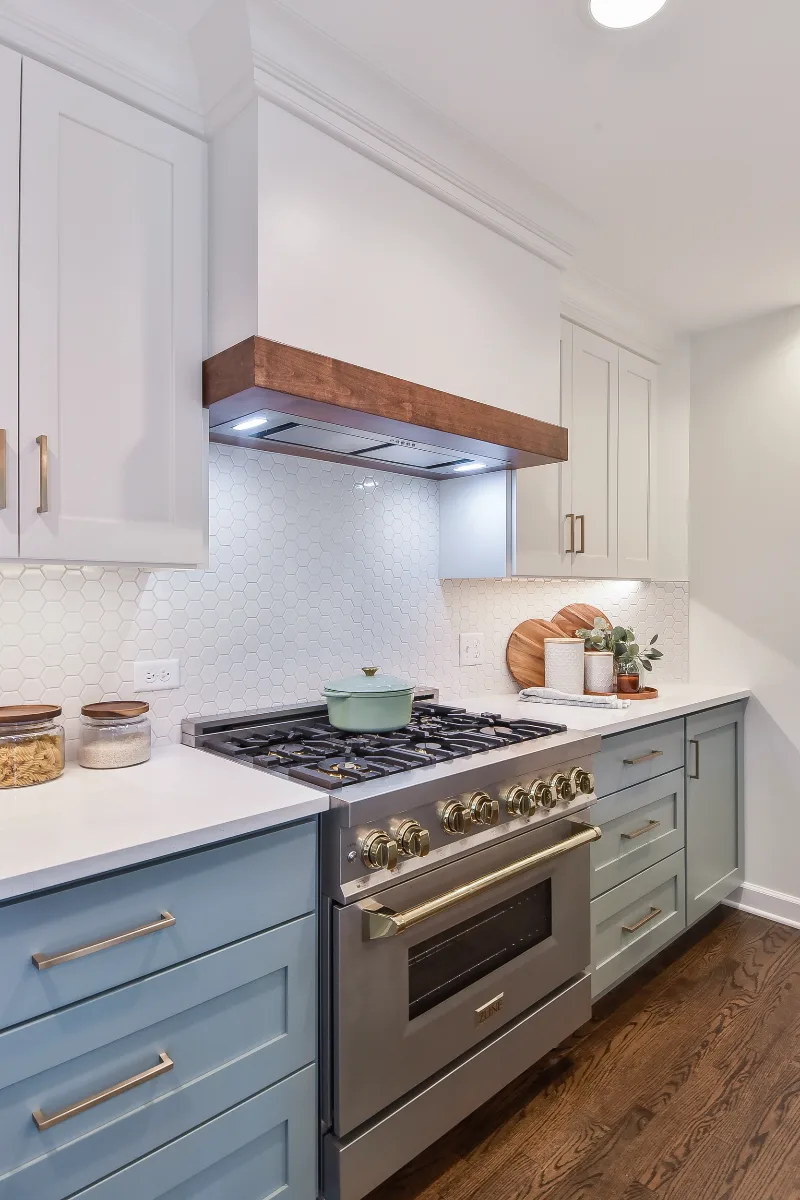 Kitchen remodel in Brentwood, TN with blue and white cabinetry and gold accents. A refreshing interior kitchen transformation by Sebring Design Build.
